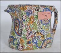 A Wade Compacto teapot and stand, in paisley chintz, waisted, faceted form, decorated throughout
