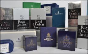 A large collection of various ceramic figurine empty boxes to include mostly Royal Doulton and