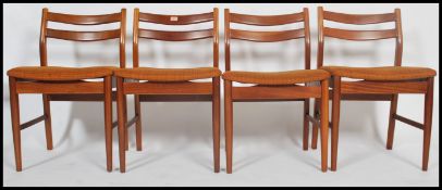 A set of 4 1970's teak Danish style retro chairs having propeller  style back rests being raised