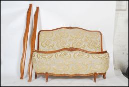 A 20th century French tapestry upholstered beech wood reeded corbeille double bed. The upholstered