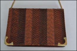 A vintage 20th century ladies Snakeskin evening / clutch bag with ,suede lining together with