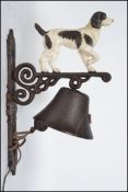 A vintage style cast iron dog bell having a rococo style angular wall bracket pierce decorated