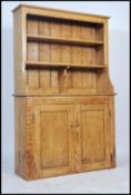 A 19th century Victorian country pine Welsh Dresser having  twin cupboard doors to the dresser