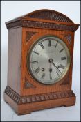 An Edwardian oak cased bracket clock by Courlander of Croydon London. The silvered dial with roman