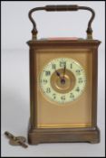 An early 20th century brass carriage clock, possibly French having an enamel face with Arabic