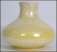 An early 20th century Moorcroft bulbous baluster vase of squat form having a yellow lustre finish.