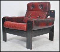 A stunning vintage mid century Danish ox blood leather armchair / lounge chair, on ebonised wooden