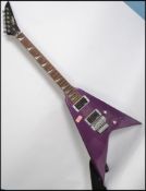 A vintage style 6 string electric axe shaped 5 way guitar having a shaped body with sloped mother of