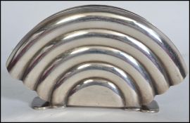 A 1930's Art Deco silver plated WMF type letter rack of arched shell form being stamped to the
