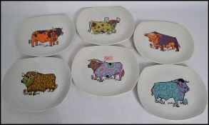 A set of original retro 1970's Beefeater plates each with a different style of cow pattern,