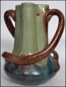 An early 20th century Charles Brannam type North Devon twin handled large pottery vase having drop