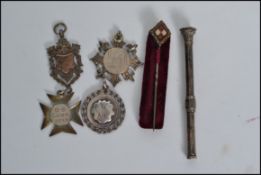 A group of silver hallmarked fobs, a silver pusher pencil and a masonic agate stick pin brooch,