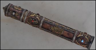 A early 20th century Oriental copper scroll holder, decorated in brass with floral symbols and