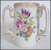 A 19th century continental three handled loving cup / mug of tall cylindrical form having handpainte