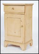 A 19th century continental pine pedestal pot cupboard / bedside cabinet having a single drawer being