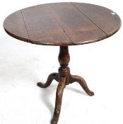 A 19th century Georgian country oak tilt top table. Raised on splated tripod base with a circular