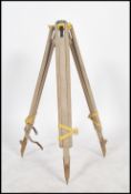 A vintage 20th century industrial / architects wooden and aluminum surveyors adjustable tripod