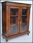 A Victorian walnut and marquetry inlaid pier cabinet being raised on a plinth base with flared top