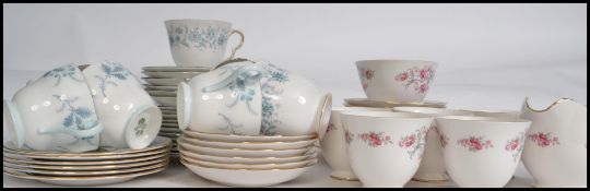 A good group of china ceramic chintzy pattern trios and part tea services to include cups,