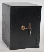 A vintage early cast iron heavy security safe having door to front complete with key