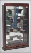 A 20th century Chinese hardwood wall mounted display cabinet, the glazed panel door opening to