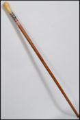 A 19th century ivory handled malacca walking stick cane having a silver collar depicting an oak tree