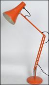 A vintage 20th century retro industrial anglepoise desk lamp in original orange paint raised on