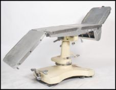 A good mid century Industrial / medical x-ray examination table having multiple folding steel