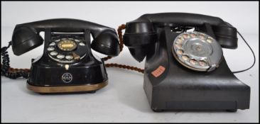 Two vintage retro 20th century bakelite ring dial telephones in black having an Arabic numeral dials
