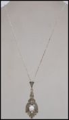 A silver Art Deco style ladies marcasite and opal necklace pendant and chain complete in the