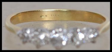 An 18ct gold 5 stone ring set with five graduating diamonds. Mark worn. Tests 18ct gold. Size M.