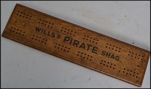 A rare and early 20th century cribbage board - advertising for Wills ' Pirate ' Shag, the board with