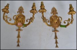 A pair of Adams style gilt metal wall sconces having central oval back plate and twin arm scroll