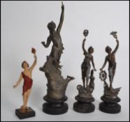 A group of vintage 20th century spelter figurines to include a pair mounted on plinth bases and a