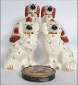 Two pairs of ceramic fireside dogs 19th and 20th century together with a 19th century framed pot