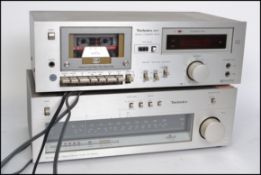 Two vintage retro hi fi Technics amps model ST 8044c having a silver finish with dials and