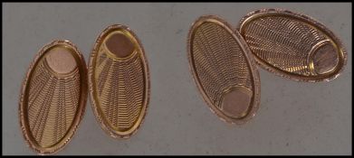A pair of hallmarked 9ct gold Art Deco mens cufflinks having etched sunburst decoration. Weight 5.