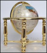 A 20th century hard stone and brass desk terrestrial globe, inlaid with various specimens. Measures: