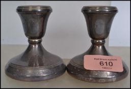 A pair of silver hallmarked stub candlesticks by Hampton Utilities, Birmingham date letter p for
