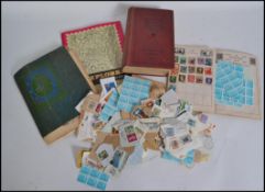 A collection of kiloware loose stamps and stamp albums, many loose stamps and stamps in albums