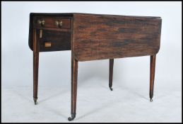 A 19th Century mahogany pembroke table, with frieze drawer and dummy drawer, brass ring handles on