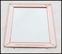 A 1930s Art Deco wall mirror of rectangular shape, having a central rectangular glass with a peach