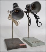 A pair of stunning vintage mid 20th century industrial lab stands raised on a cast metal base and
