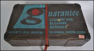A vintage / retro 20th century dry cleaning laundry case with notation to the front for Guarantee