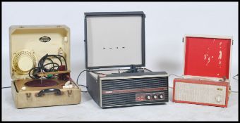 A vintage mid 20th century Bush vinyl record player having a BSR 4 speed deck set in a two tone case