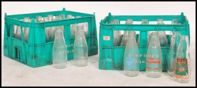 A collection of vintage and retro advertising and plain milk bottles for Dunsford dairies dating