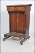 A Victorian teacher’s lectern, the sloping top enclosing a fitted storage compartment on uprights