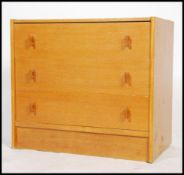 A retro 20th century oak chest of drawers, the drawers with pull handles and raised on shaped