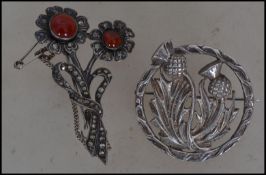 A hallmarked silver Scottish thistle brooch pin by Robert Allison together with another flower spray