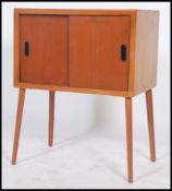 A vintage 20th century teak small sideboard entertainment cabinet raised on tapering legs having